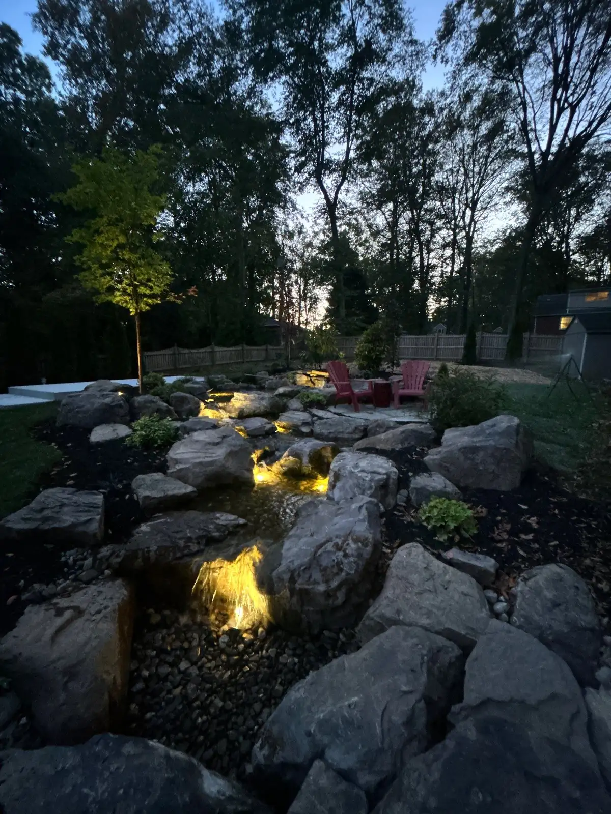 Finished backyard pond and waterfall by Rock Water Ponds