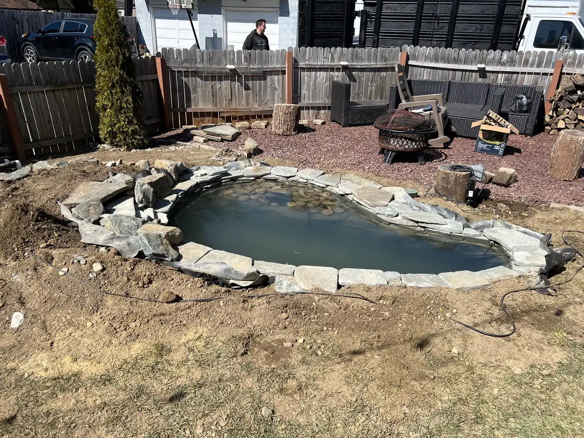 Finished water feature with stonework and refined landscape detail
