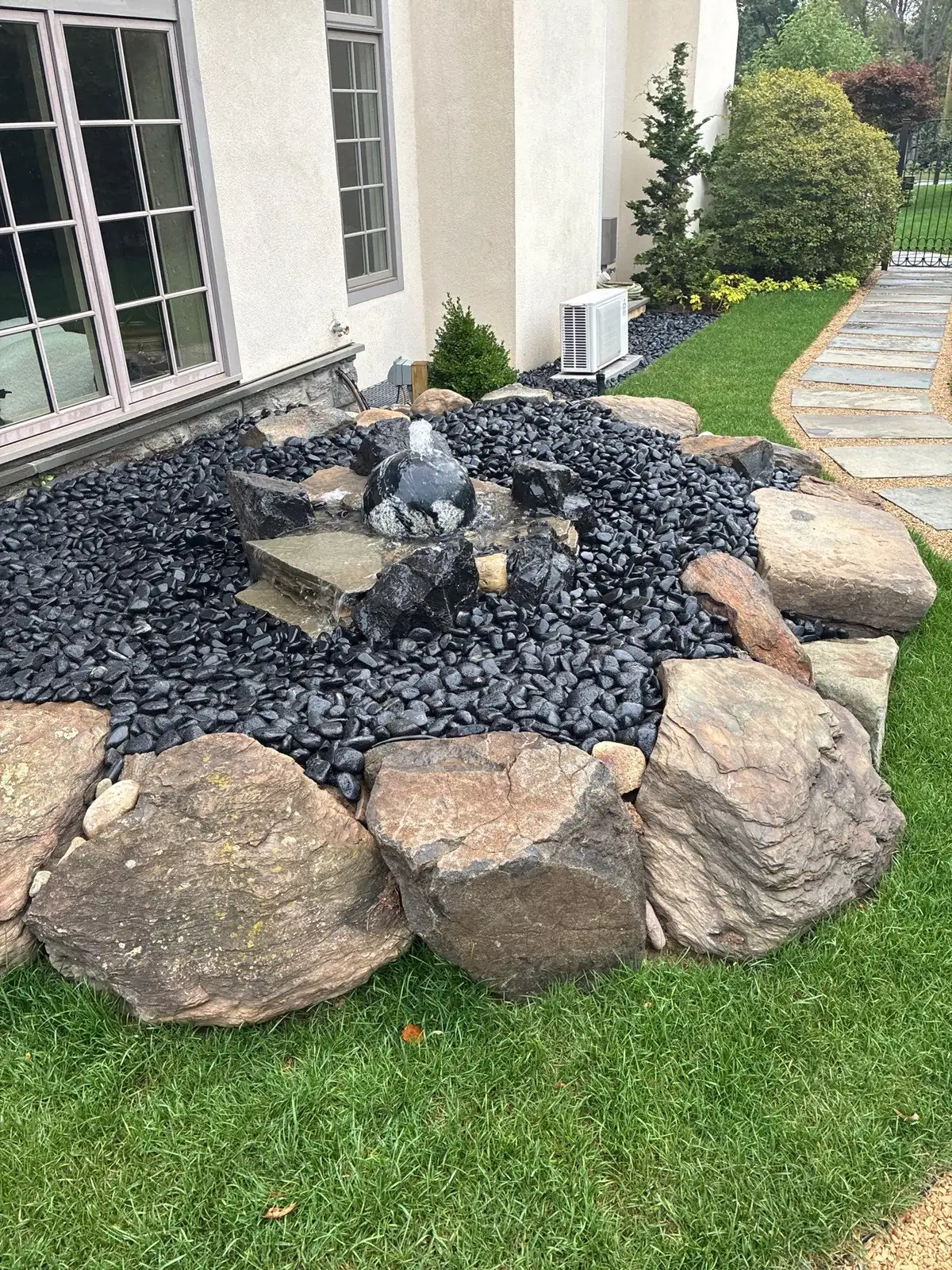 Custom pond construction with boulders and liner preparation